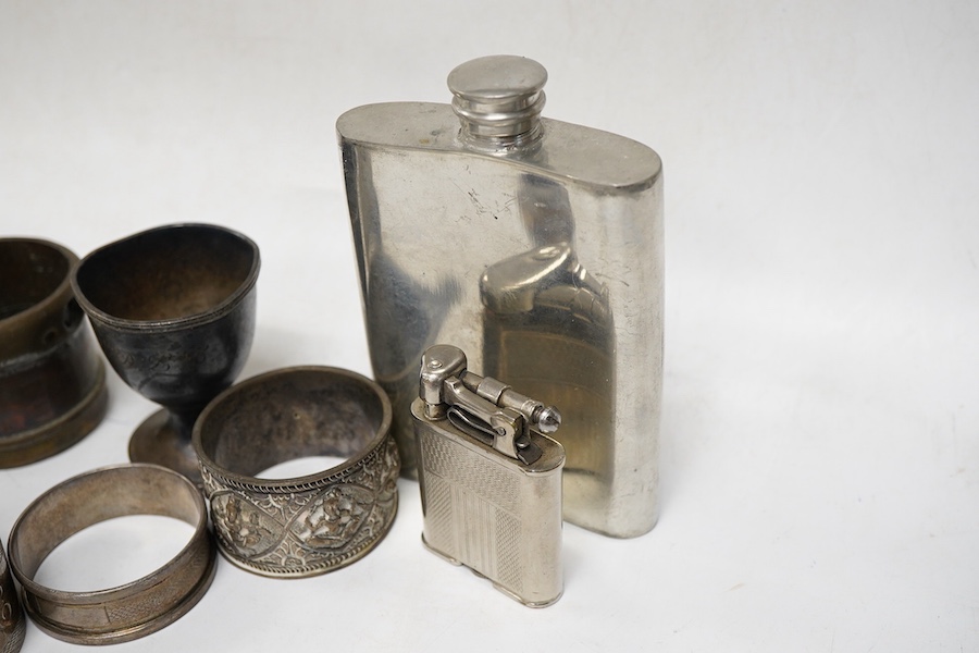 Four assorted silver napkin rings, an Indian white metal napkin ring, a small silver egg cup and four other items.